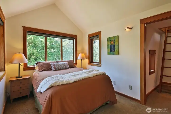 Bedroom #3 looking out upon the whole Western side of the property has vaulted ceilings and nook space just beyond the left edge of this photo. Let's check out the Crow's Nest via the walk-in closet (see ladder right edge of photo). Bedroom #3 looking out upon the whole Western side of the property has vaulted ceilings and nook space just beyond the left edge of this photo. Let's check out the Crow's Nest via the walk-in closet (see ladder right edge of photo).