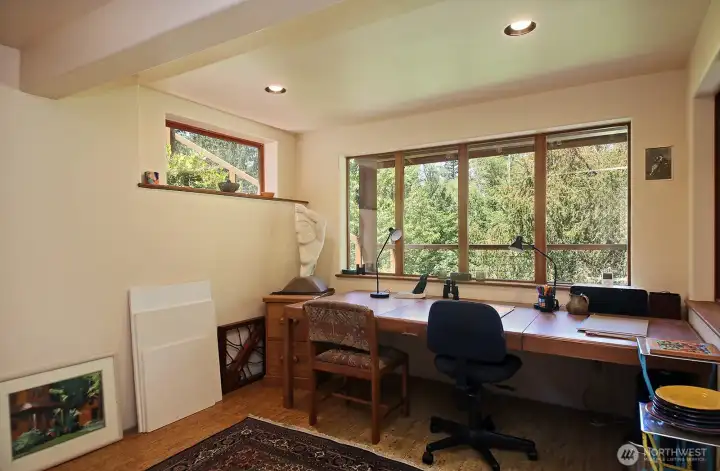 Studio/Flex Space w/cork floors and just as much space behind the photographer's back with storage shelves and space for a freezer (the freezer in this space does not convey). Across the hall from the Studio is the Workshop with the Sauna Room (not in photos) between the Studio & Workshop. Studio/Flex Space w/cork floors and just as much space behind the photographer's back with storage shelves and space for a freezer (the freezer in this space does not convey). Across the hall from the Studio is the Workshop with the Sauna Room (not in photos) between the Studio & Workshop.