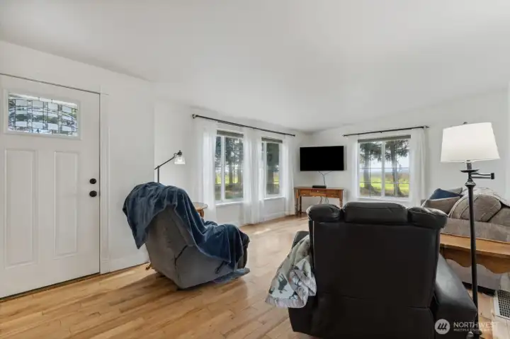Large windows in living room.  New flooring, paint and custom trim throughout.