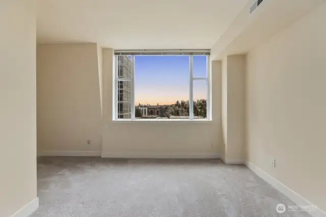 Main bedroom with view of downtown Seattle and mountains on a clear day