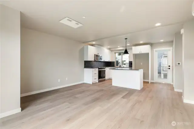 Living/Kitchen looking back to door on left which leads to the spacious deck