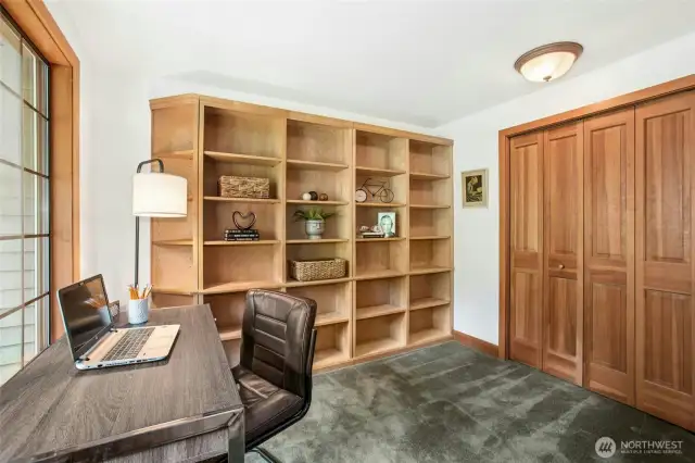 Great den/office/library with a closet and more built in bookshelves on the right side of the room.