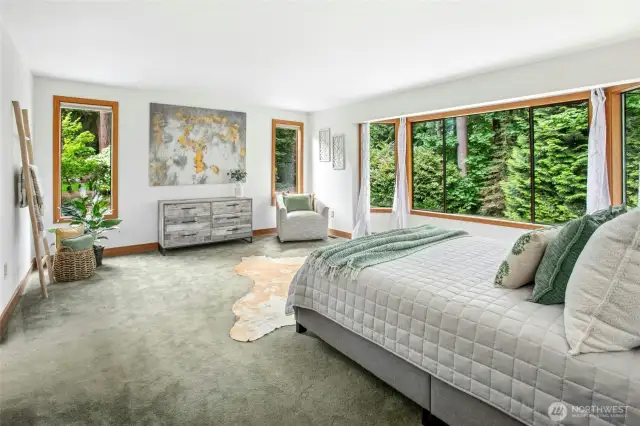 Inviting primary en suite with more gorgeous green views overlooking the backyard sanctuary.