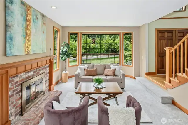 Spacious living room with wood burning fireplace off the dining room.
