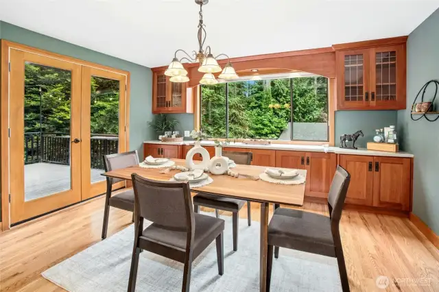 Spacious dining room with built in cabinetry and brand new french doors.