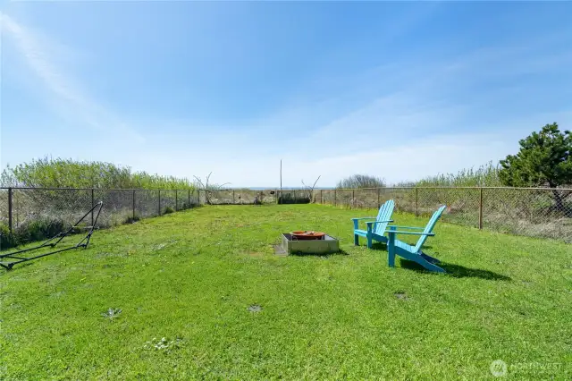 Fenced in backyard on ocean side of home