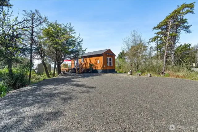 Large graveled area for parking, with power & sewer for RV's