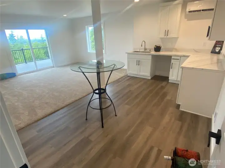 Studio/Mother-in-Law apartment/teen-suite type room with a slider out to the lower deck & staircase to the ground & lower parking pad.