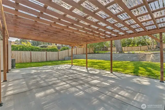 Massive covered patio leads to green grass