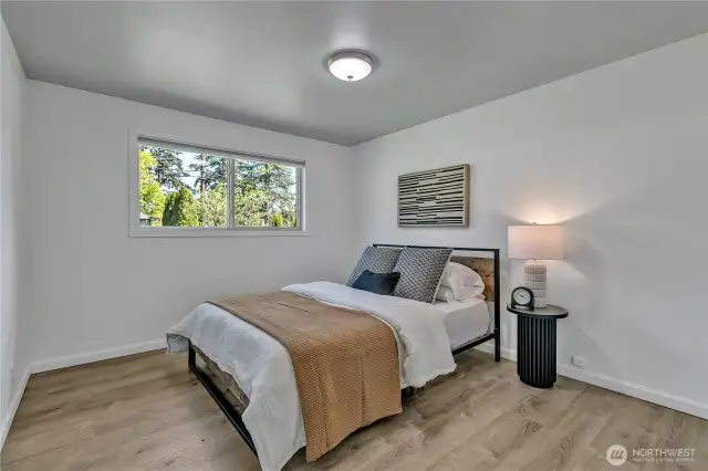 Primary Bedroom with tons of natural light and vinyl plank flooring