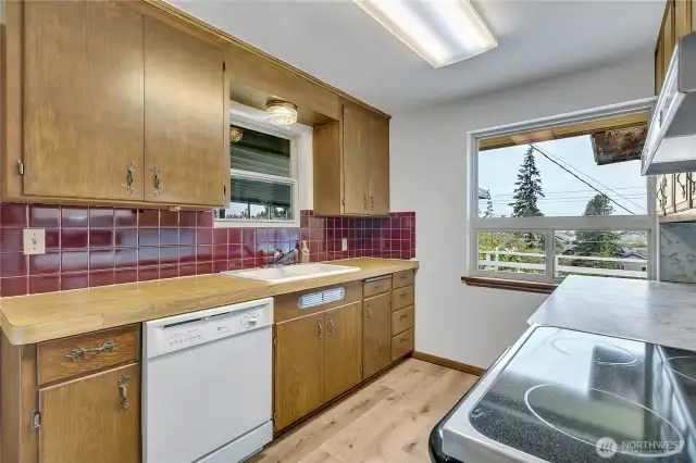 Kitchen overlooks covered deck and leads to single car garage.