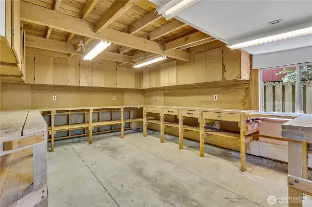Workshop features cabinets, workbenches and plenty of electrical outlets.