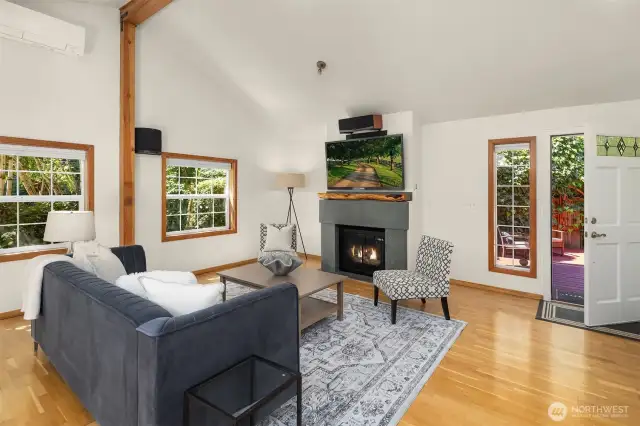 Open great room with vaulted ceilings and exposed wood beam. Limestone clad gas fireplace and AC/Heat mini-split for all year comfort