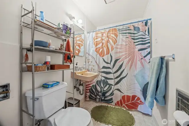 Bathroom in upper duplex unit; full bath.