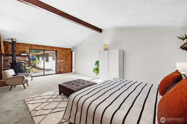 a Versatile 338 SF Room with vaulted ceilings, a cozy wood stove, this incredible room offers endless potential. Currently staged/used as a primary suite, there's even room to add an ensuite; bath could be back to back from laundry/bath or easily extended on right side.  also could easily function as a spacious rec room, guest retreat, or home studio. —a rare opportunity to customize and elevate your lifestyle!