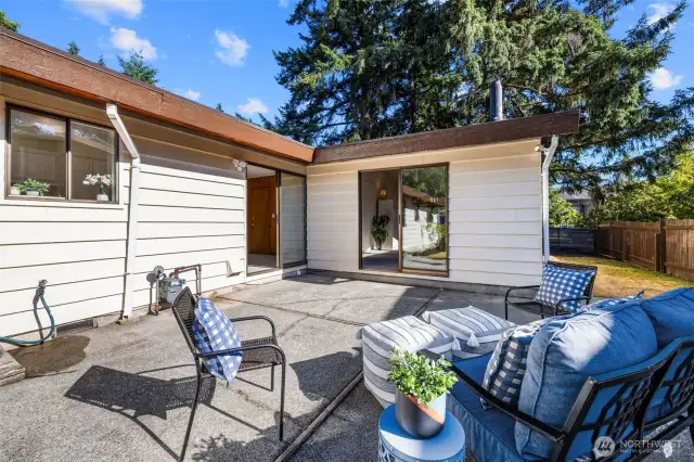 Garden Charm Meets Function with sliders from kitchen/living area & primary suite   Ample room to plant, play, or just enjoy the greenery. The patio and garden areas provide a perfect balance of charm, function, and space to make your own.