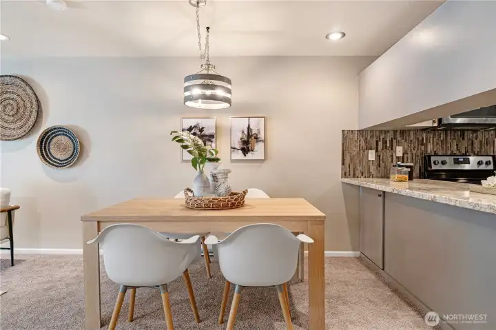 The spacious breakfast bar leads beautifully to the dining space. There is upgraded lighting throughout this wonderful home.
