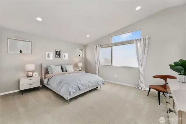 stunning primary bedroom with vaulted ceilings
