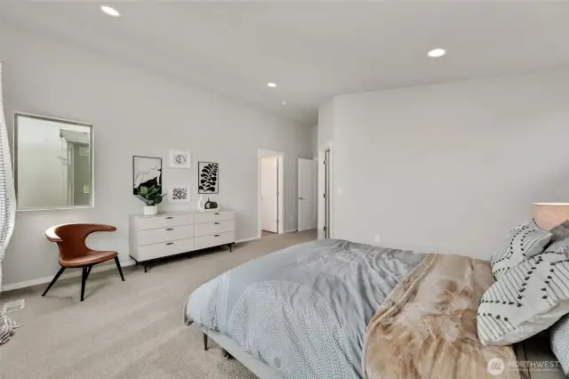 stunning primary bedroom with vaulted ceilings