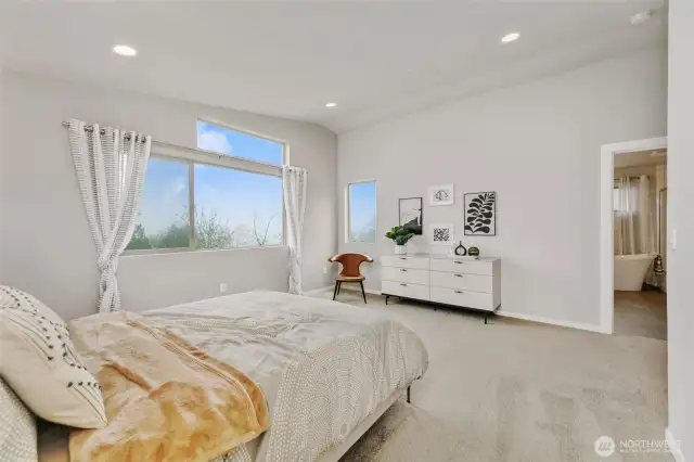 stunning primary bedroom with vaulted ceilings