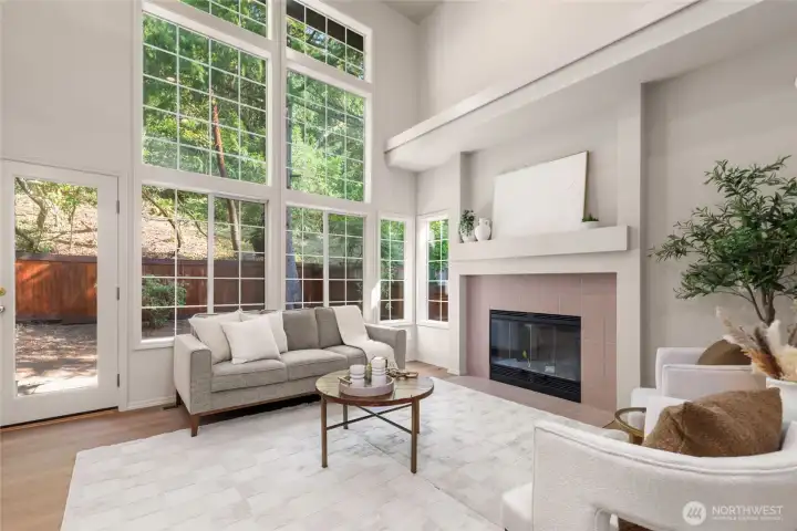 The great room off the kitchen offers more natural light and nature out your back door.  Gas fireplace to set the mood.