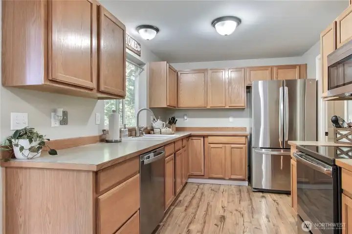 Kitchen view on, I love the flooring and included stainless steel appliances. The view out of the window is glorious!