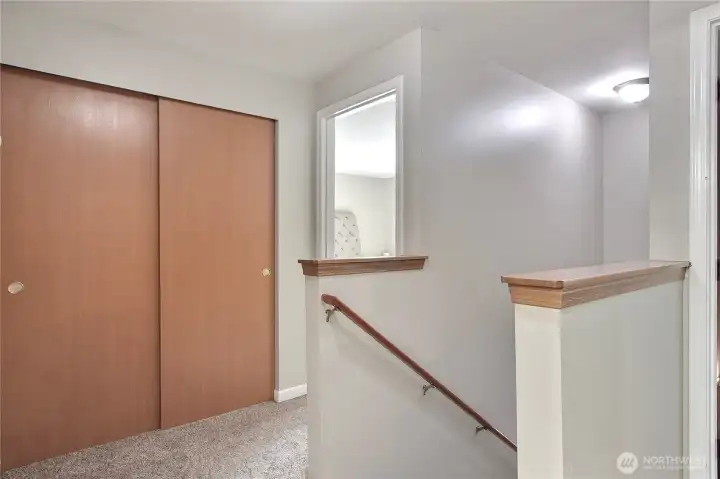 Upstairs landing view, HUGE linen closet, primary suite is straight ahead. Other bedrooms and full bath are on back and other side of the upper level.