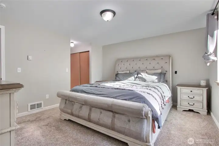 Primary suite view one, ample in size, nice larger windows as well. His and hers closets!