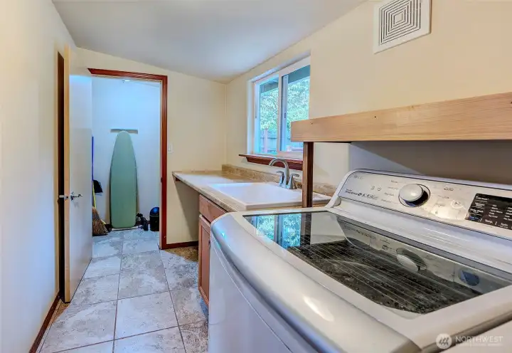Tiled Laundry Room Leads To Pantry, Hot Water Heater, And Storage Area.