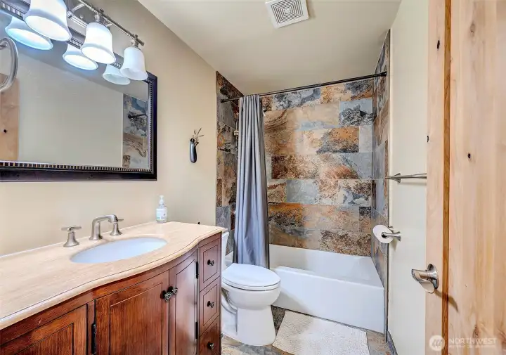 All Remodeled Bathroom With Extensive Use Of Tile & Grand Cabinetry.