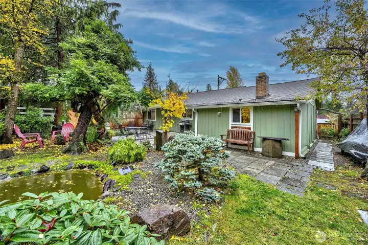 Backyard Patio Area All Professionally Landscaped With Pond And Walking Trails.