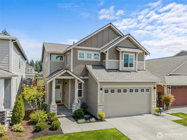 Attractive curb appeal with thoughtful landscaping, covered entry, and a welcoming exterior design