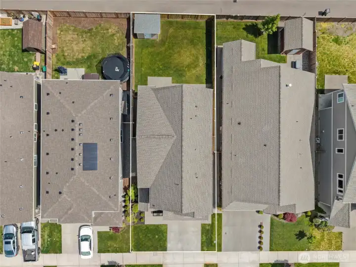 Top-down aerial with property lines highlighted gives a clear picture of the lot size, backyard space, custom shed, and the home's position within the neighborhood. A well-proportioned lot offering both outdoor living space and the comfort of a fully fenced yard.