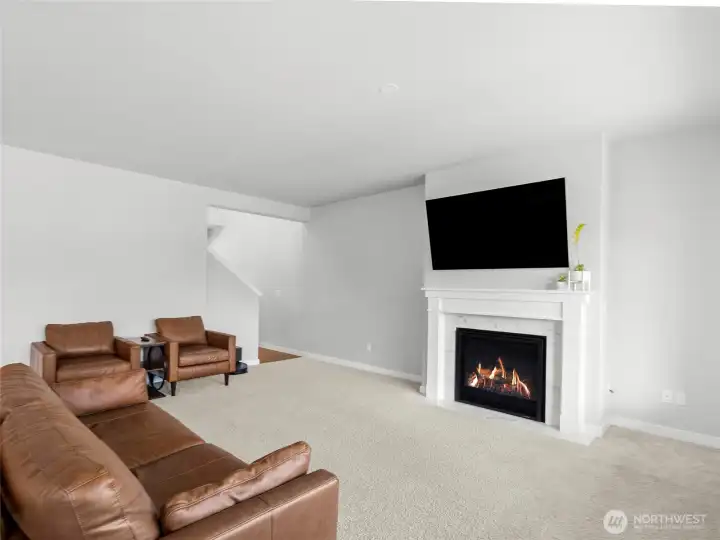 The spacious living room is anchored by a stunning gas fireplace with marble surround and classic white mantel. This open comfortable space to is perfect for relaxing and entertain year-round, adjacent to kitchen and dining room.