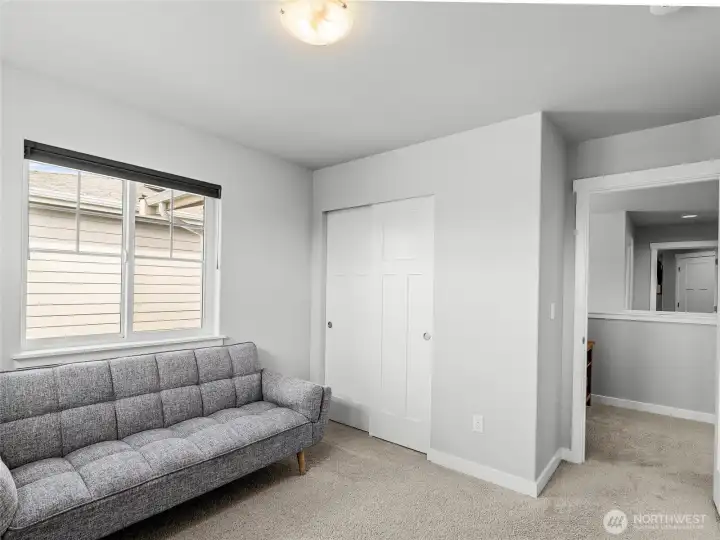 Versatile fifth bedroom featuring plush carpet, a sliding double closet, and a bright window. Currently used as a flex room, this space adapts easily to a guest room, hobby room, or additional home office to fit your needs.