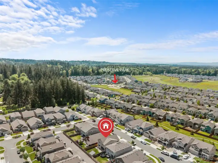 Aerial view highlighting the home's location within the community, with Preserve Park just steps away. Enjoy easy access to open green space, walking paths, and the natural beauty of the surrounding Pacific Northwest landscape — right in your neighborhood.
