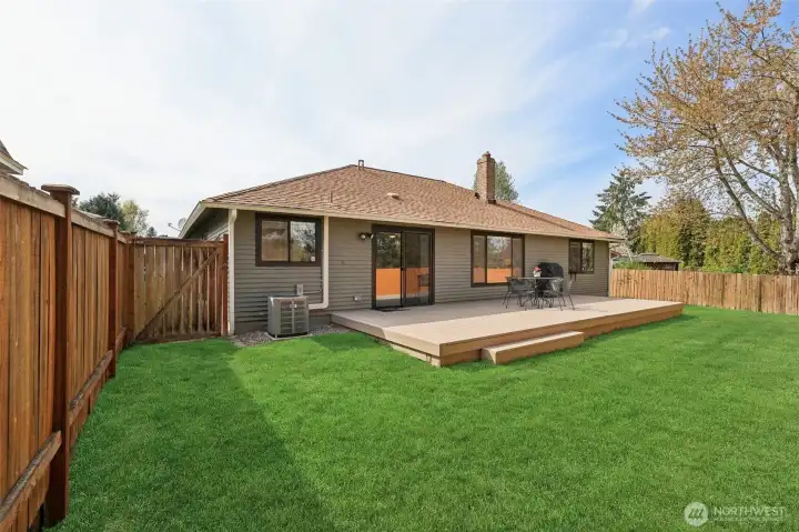 New deck overlooking a fully fenced backyard