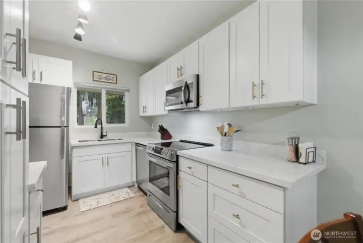 Quartz counters. Lots of work space and great natural light.
