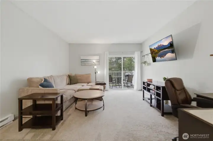 Generous living room with newer luxury vinyl flooring.