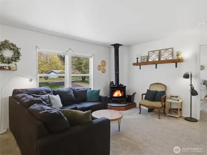 Cozy wood stove efficiently heats the entire home, making winter months warm and inviting.