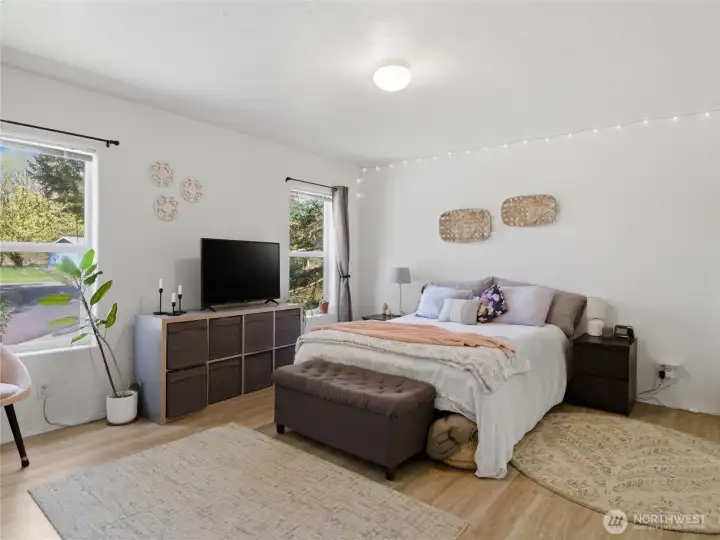 Spacious primary suite boasts a 3/4 bath and walk in closet