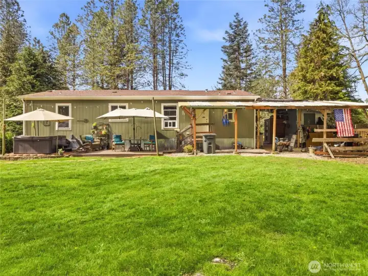 The large backyard and patio provides a great space for relaxing or entertaining.  Hot tub stays