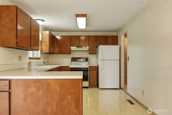 Large kitchen with plenty of cabinets.