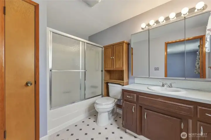 Primary bathroom with full bath and linen closet.