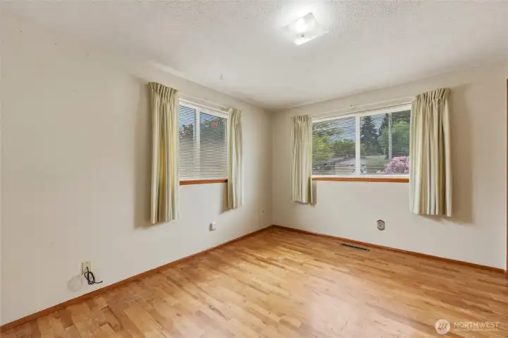 Guest bedroom #2 with oak hardwood flooring.