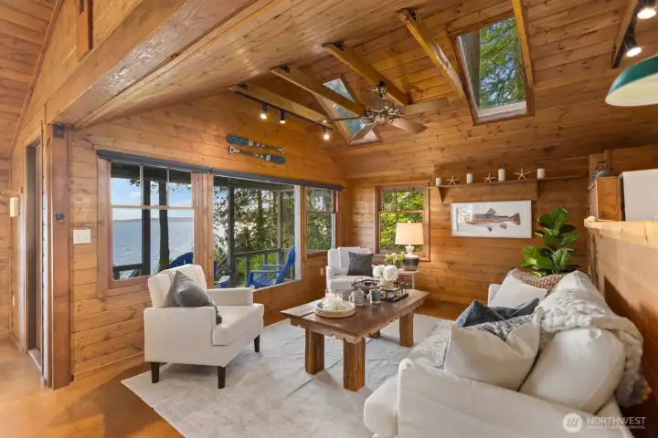 This cozy living area features vaulted ceilings and even more skylights, paired with a show-stopper view to the West for Puget Sound, Olympic mountain, and sunset views. This cozy living area features vaulted ceilings and even more skylights, paired with a show-stopper view to the West for Puget Sound, Olympic mountain, and sunset views.