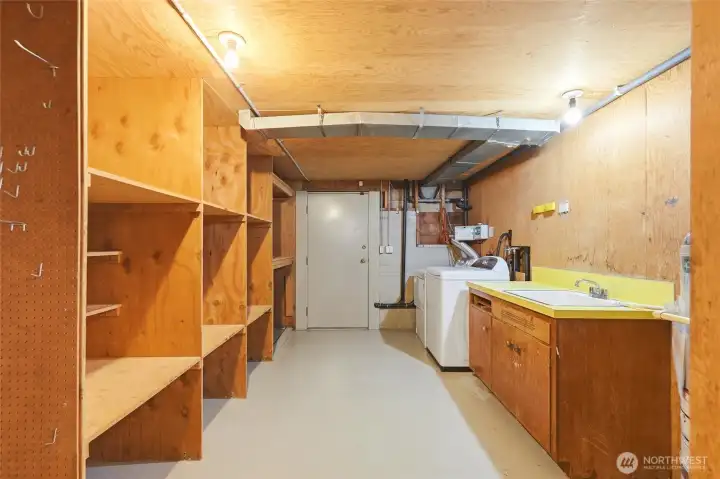 Utility room with exterior door and plenty of storage.