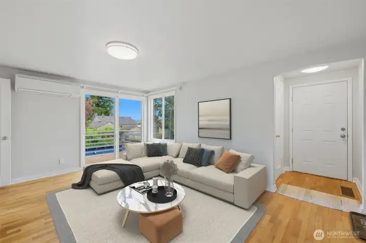 Entry and living space with access to large deck. - Virtually Staged