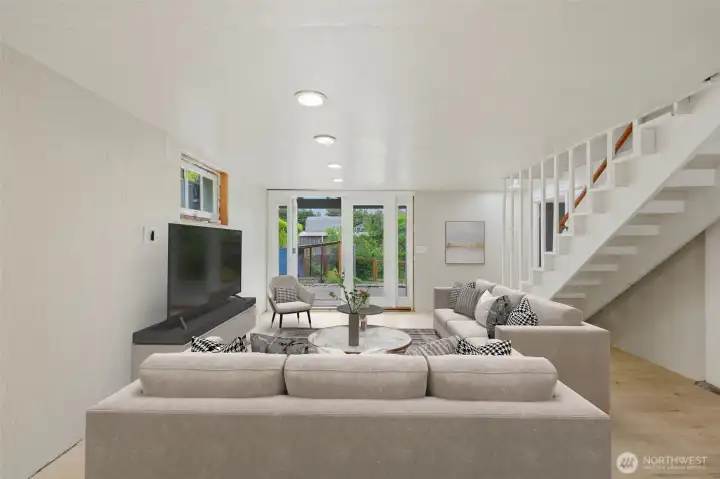 Basement, partially finished with french doors that lead to private backyard -Virtually Staged