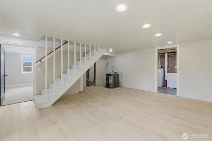Door on left is perfect space for another bedroom or office. Pellet stove and access to unfinished bath, laundry and extra room.